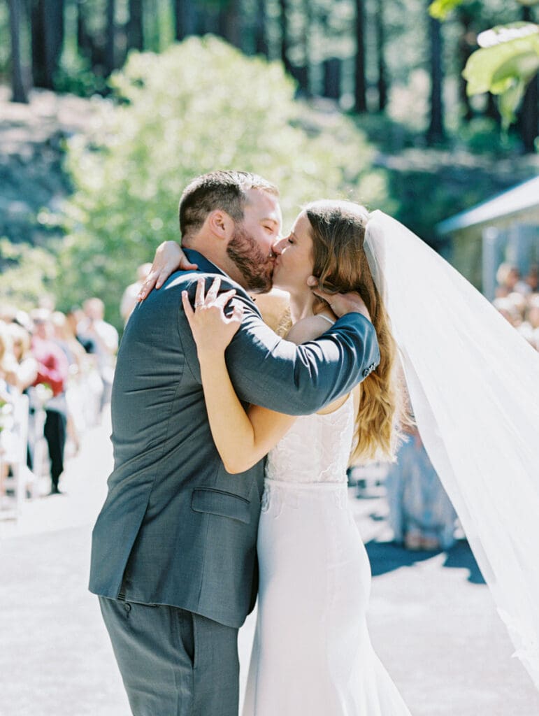 Wedding Ceremony Kiss in Galena Creek Hatchery  by Lake Tahoe film wedding photographer 