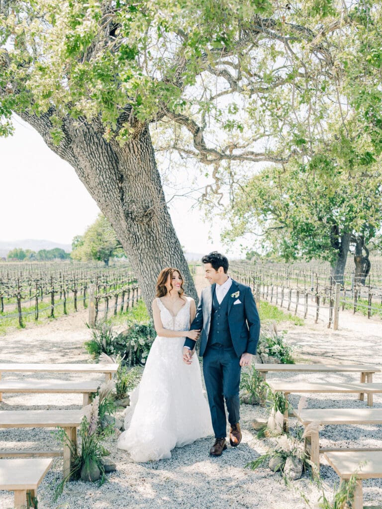 Bride and Groom walking down the isle at Intimate Vineyard Wedding at Sunstone Winery