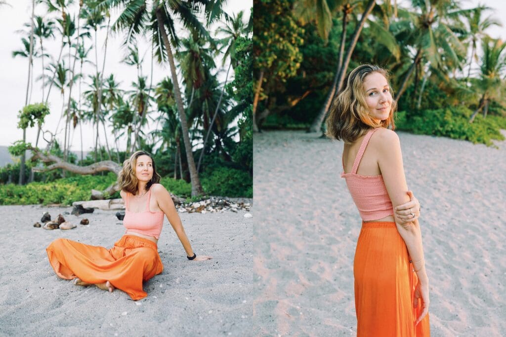 A woman in an orange skirt poses on the beach surrounded my tropical palm trees, captured by a Big Island Hawaii portrait photographer.