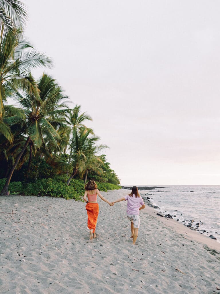 run into the sunset Couples Engagement Photo on the tropical Big Island of Hawaii beach by Hawaii film wedding photographer