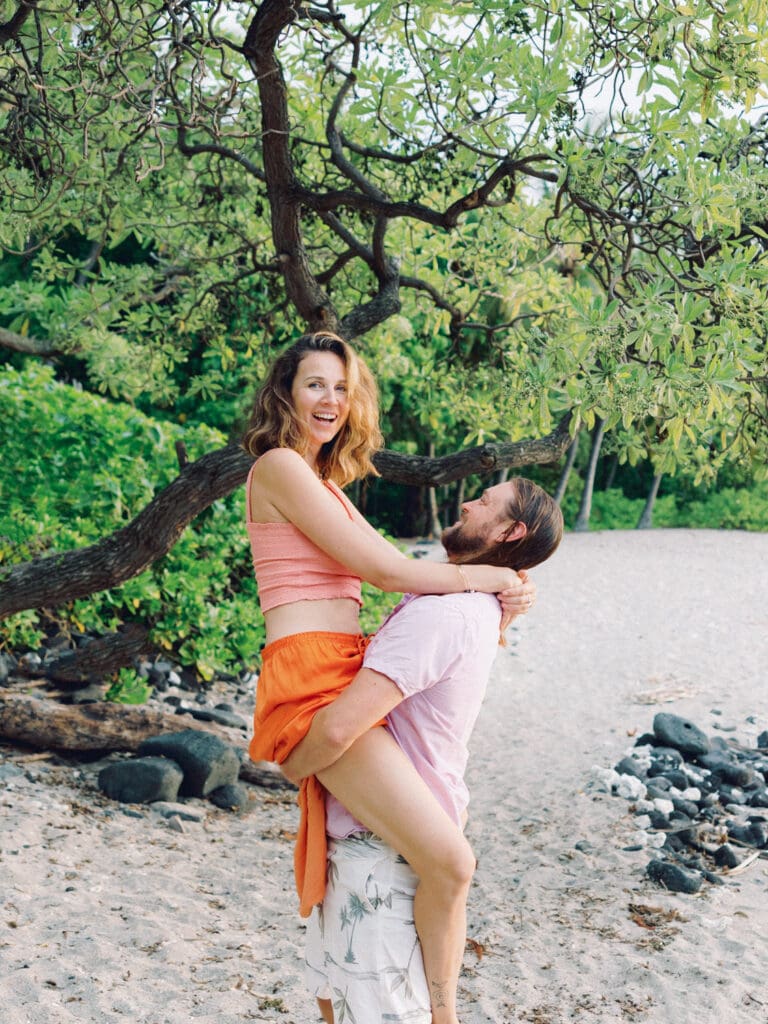 Fun Couples Engagement Photo on the Big Island of Hawaii beach by Hawaii wedding photographer