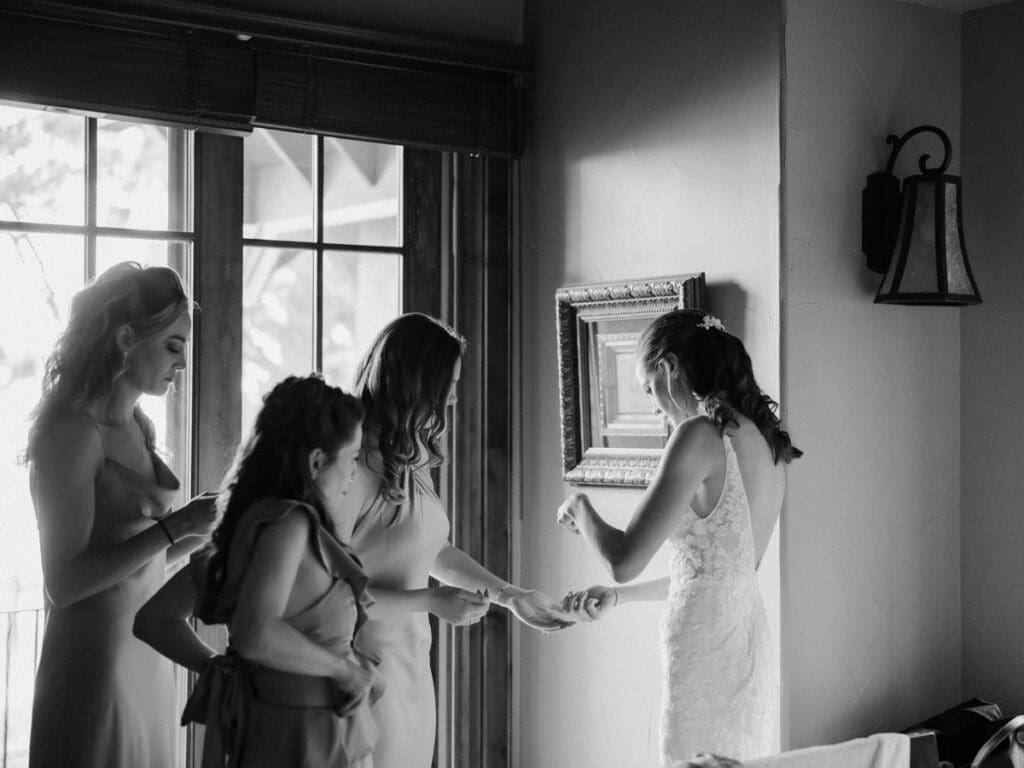 A bride in a stunning wedding dress poses gracefully with her bridesmaids