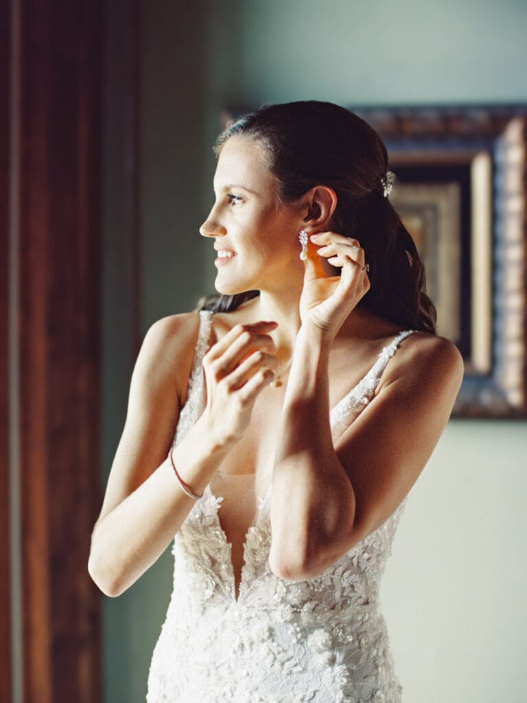 A bride in a stunning wedding dress poses gracefully at Edgewood Tahoe Resort wedding, capturing the essence of her special day.