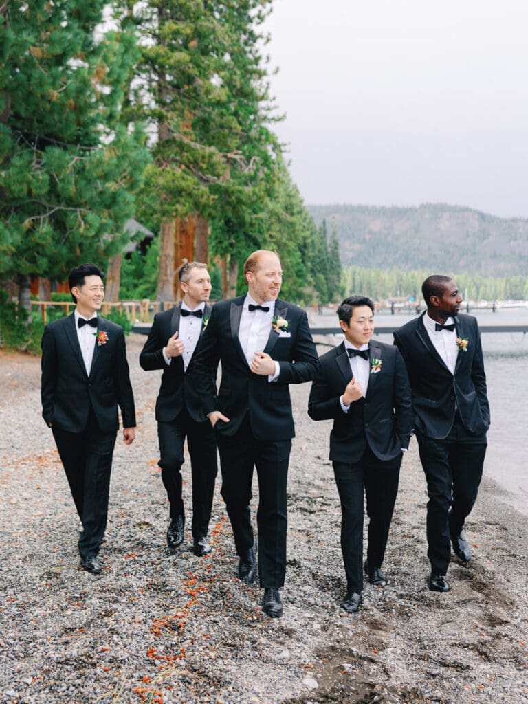 Bridesmaids walking on the beach at Edgewood Tahoe Resort wedding, highlighting the stunning backdrop of Lake Tahoe.