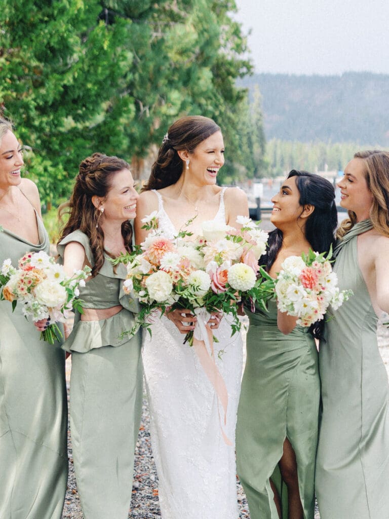 Bridesmaids laughing on the beach at Edgewood Tahoe Resort wedding, highlighting the stunning backdrop of Lake Tahoe.