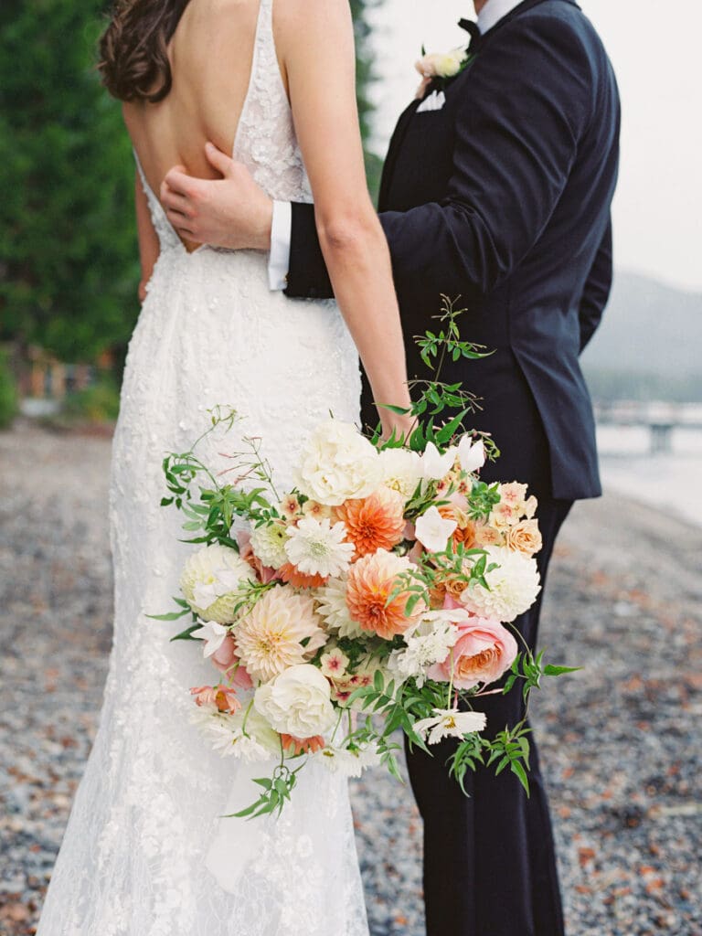 Elegant bride and groom first look portraits on the beach at Edgewood Tahoe Resort wedding, highlighting the stunning backdrop of Lake Tahoe.