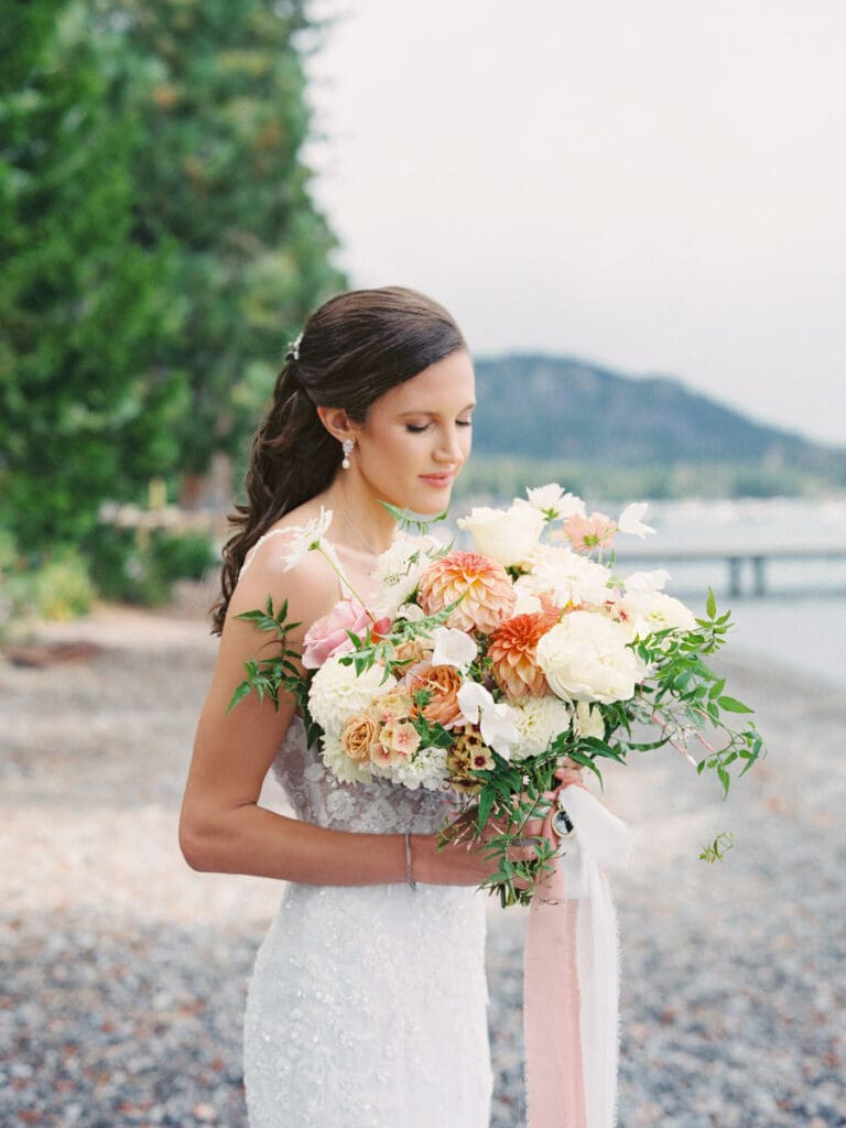 Elegant bride portraits on the beach at Edgewood Tahoe Resort wedding, highlighting the stunning backdrop of Lake Tahoe.