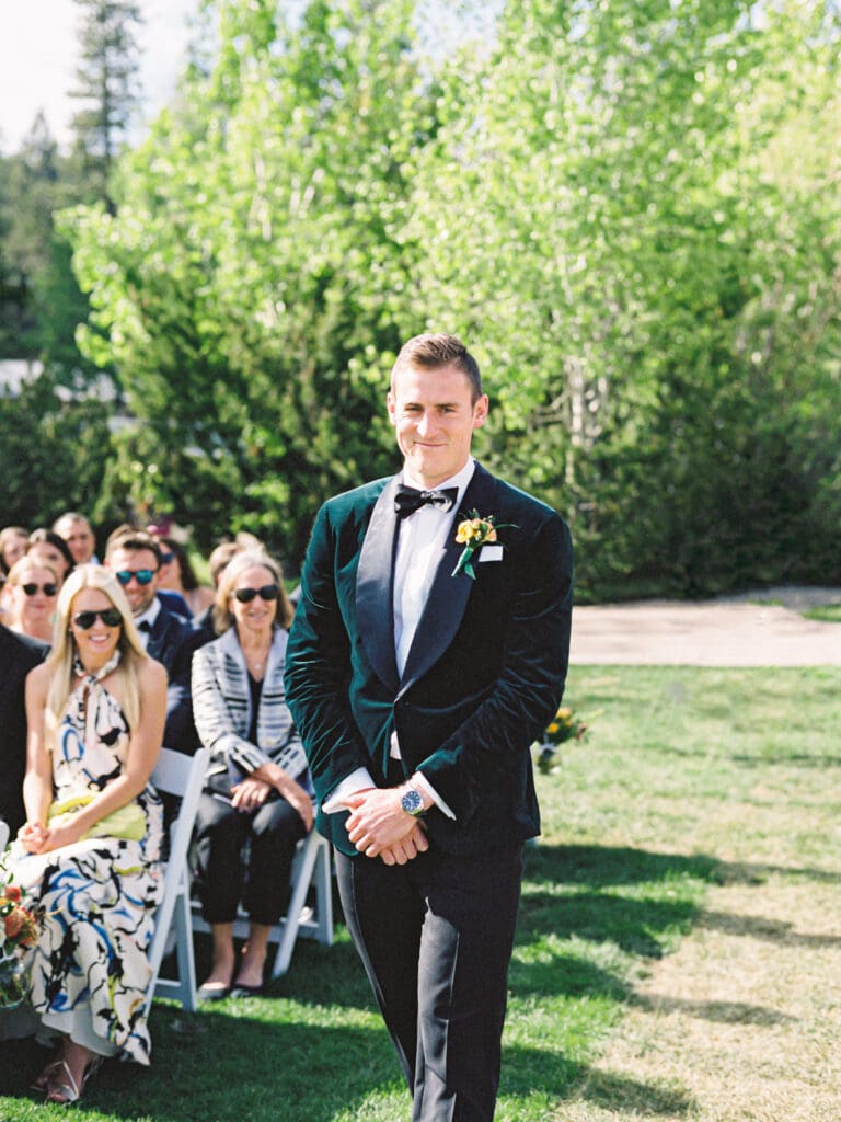 A serene beach wedding ceremony at Gar Woods, Lake Tahoe, showcasing the couple amidst a stunning lakeside setting.