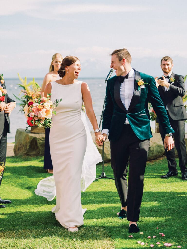 Just married bride and groom on a picturesque beach at their Gar Woods Lake Tahoe wedding.