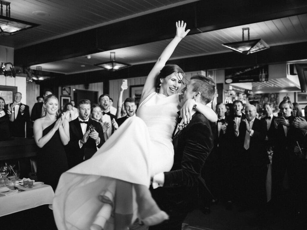 A bride and groom share their first dance at their wedding reception at Gar Woods, Lake Tahoe, surrounded by love and joy.