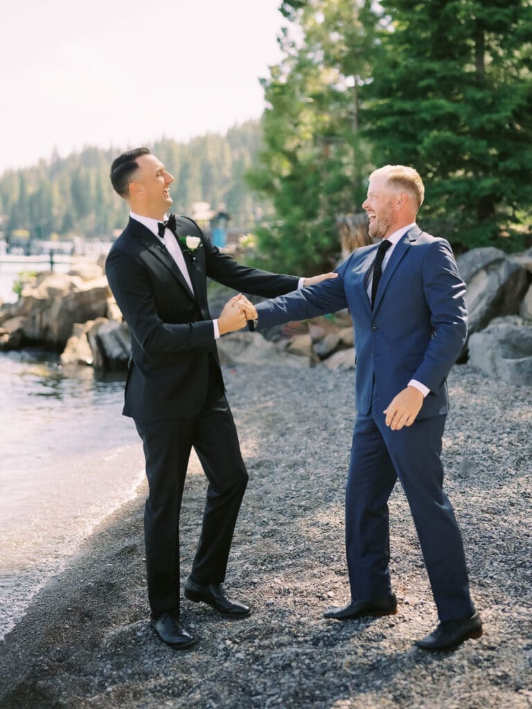 A joyful groom and best man celebrating at a wedding at Gar Woods, Lake Tahoe.