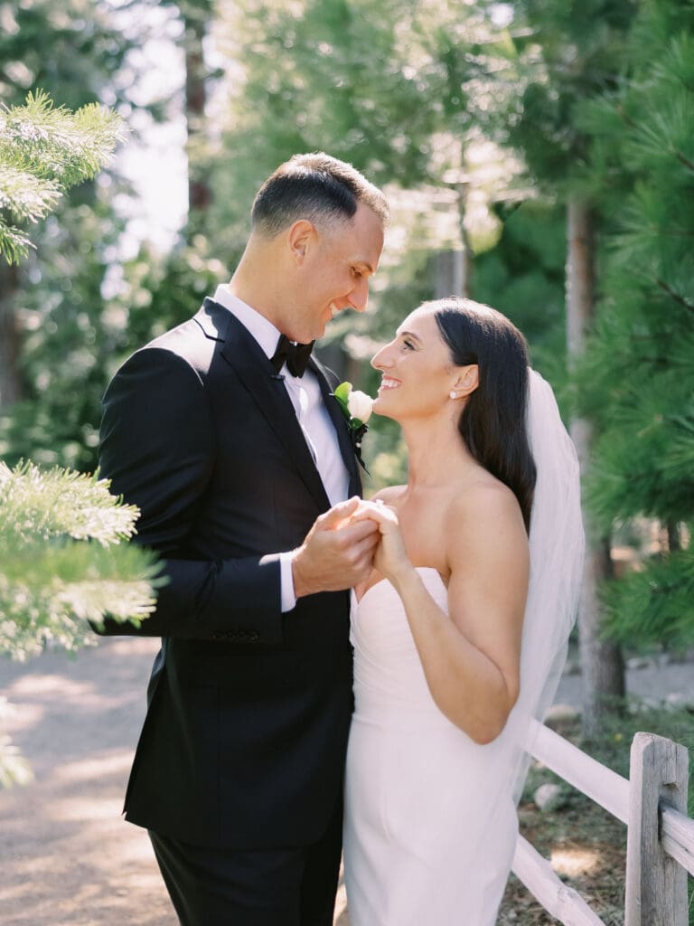 A bride and groom share a romantic moment at their Gar Woods wedding by the stunning Lake Tahoe backdrop.