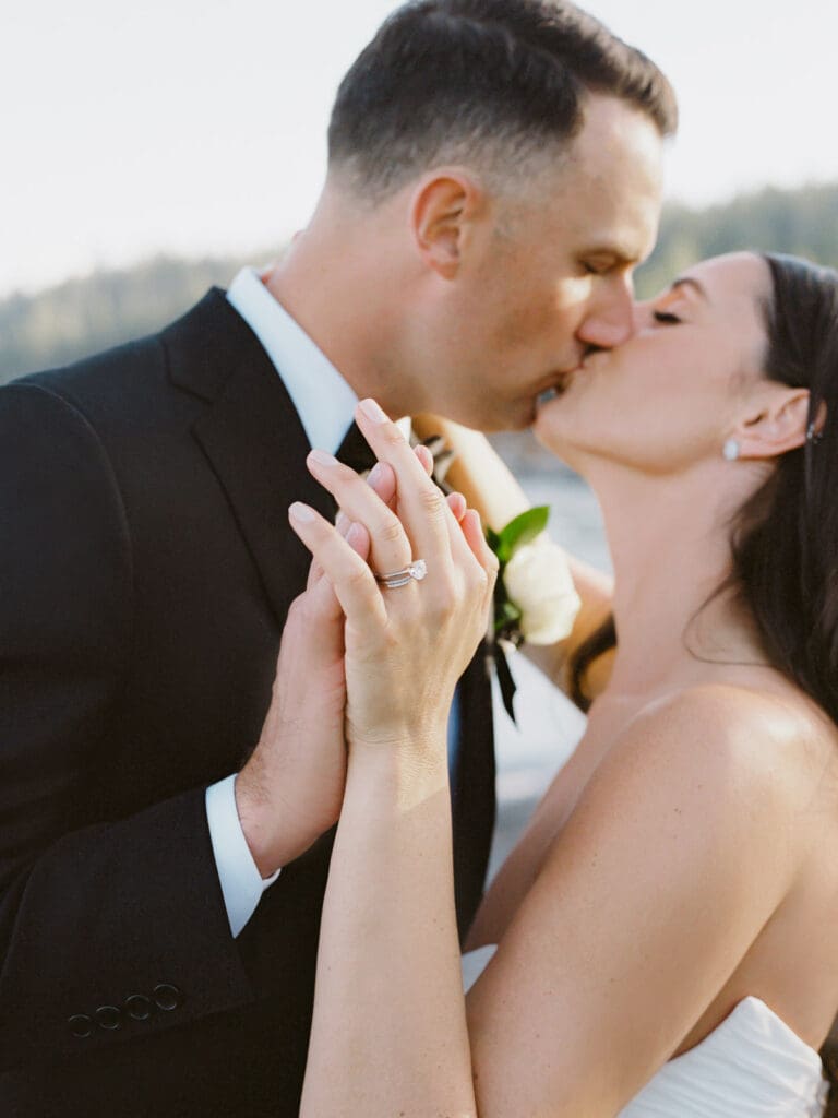 Captivating bride and groom kiss at Gar Woods, Lake Tahoe, highlighting their love against a breathtaking lakeside backdrop.