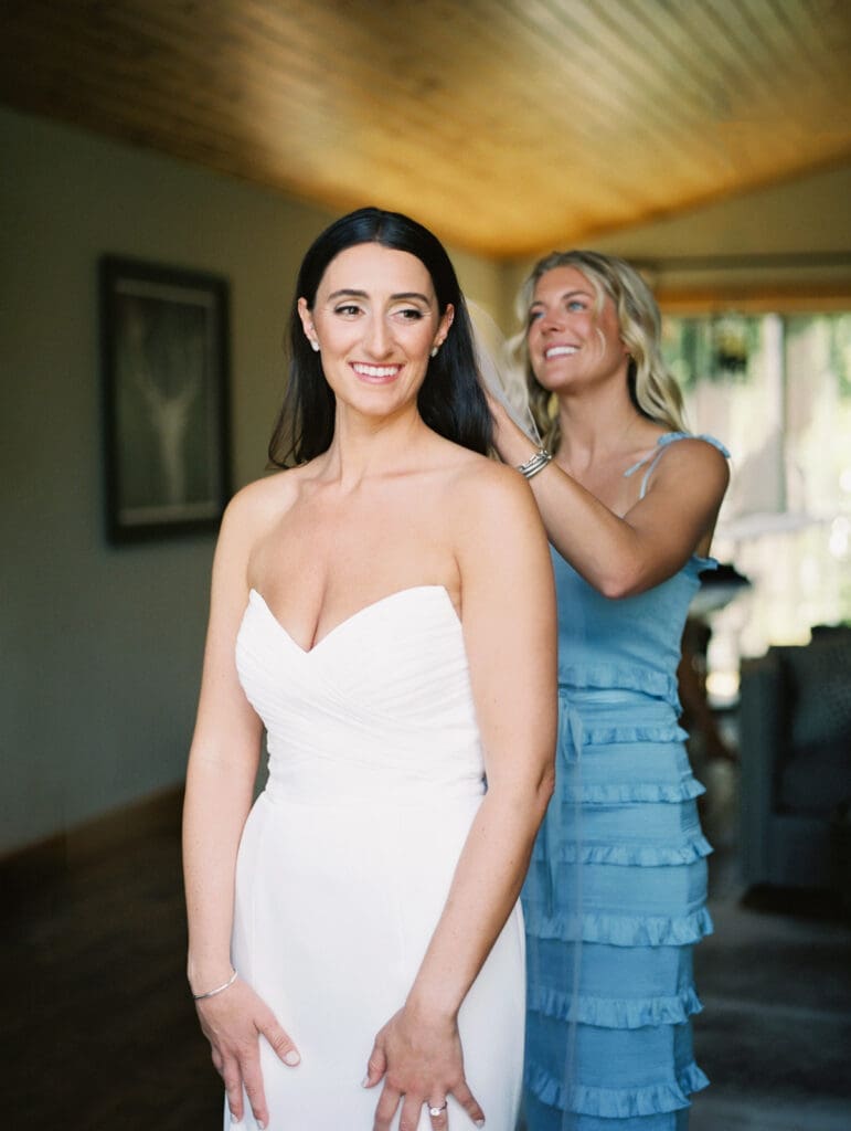 A joyful bride in her wedding attire, getting ready at Gar Woods, Lake Tahoe, filled with excitement and elegance. 