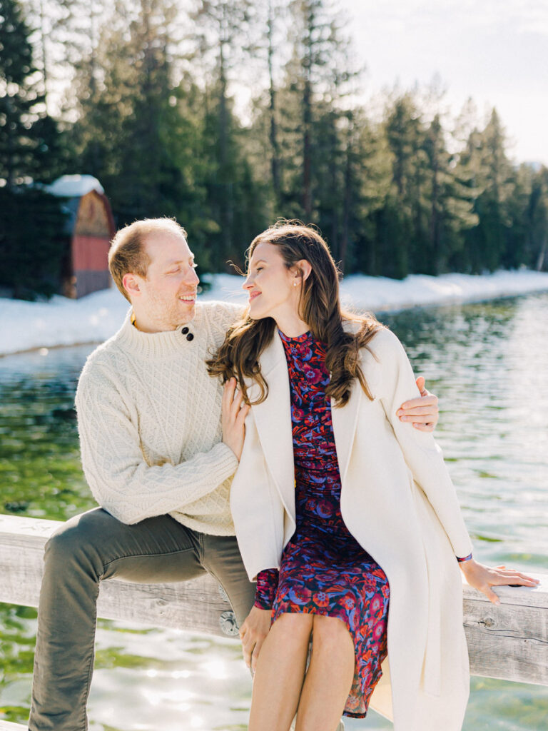 A photo of a couple smiling at Lake Tahoe Winter Engagement Shoot