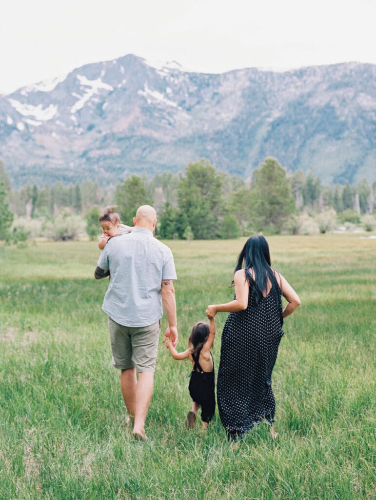 Family photo session in Tahoe meadow with mountain views by Lake Tahoe film family photographer 