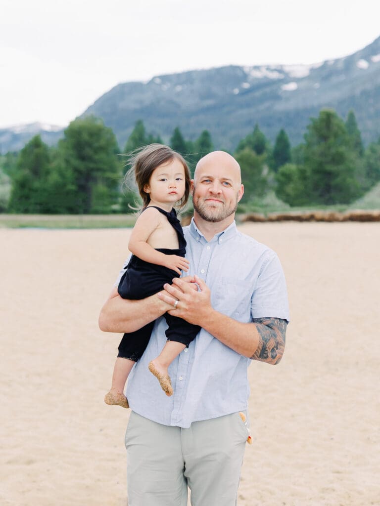 Father and daughter family photo session in Tahoe beach with mountain views by Lake Tahoe film family photographer 