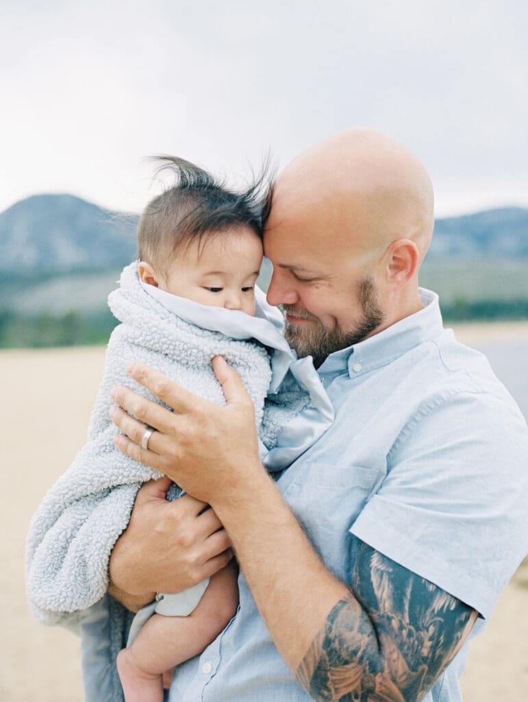 Father and son family photo session in Tahoe beach with mountain views by Lake Tahoe film family photographer 