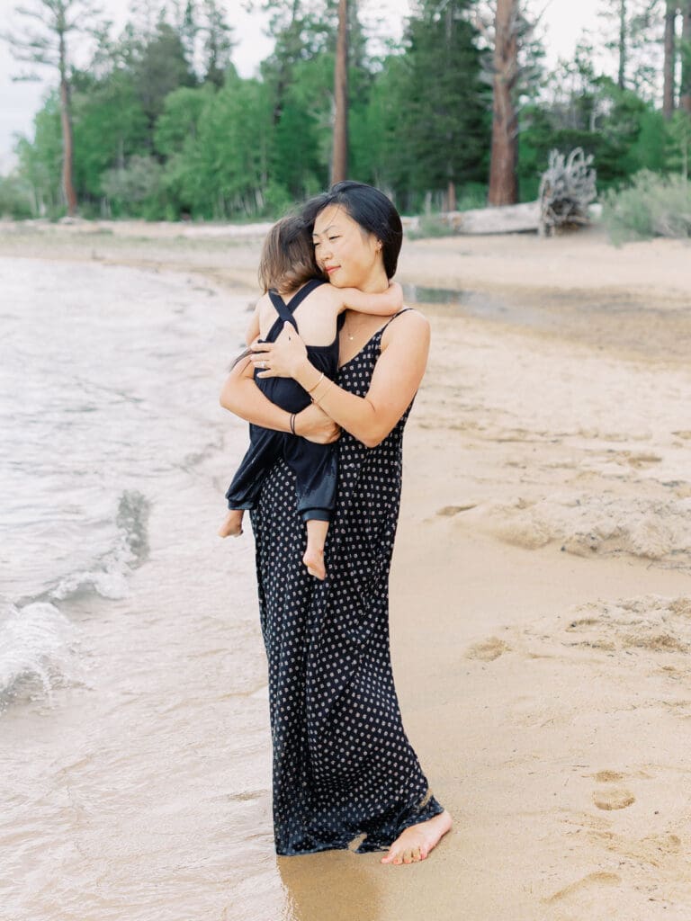 Mother and daughter family photo session in Tahoe beach with mountain views by Lake Tahoe film family photographer 