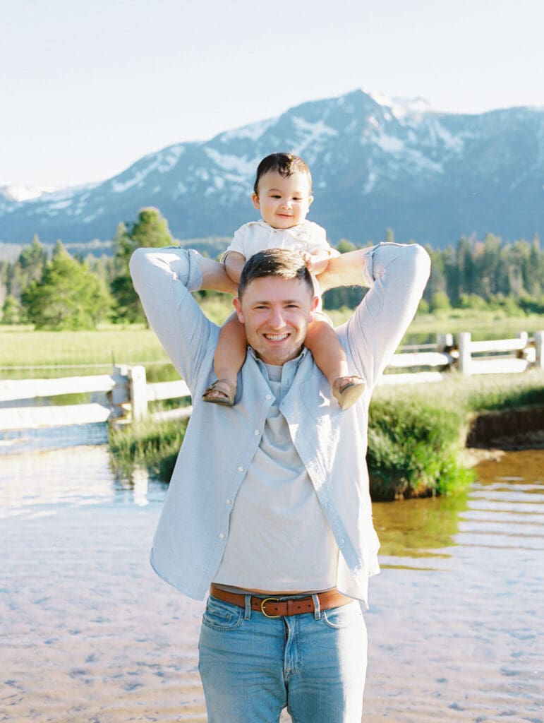 Scenic family photo session at Lake Tahoe, where a photographer captures the essence of dad and a child bonds in nature.