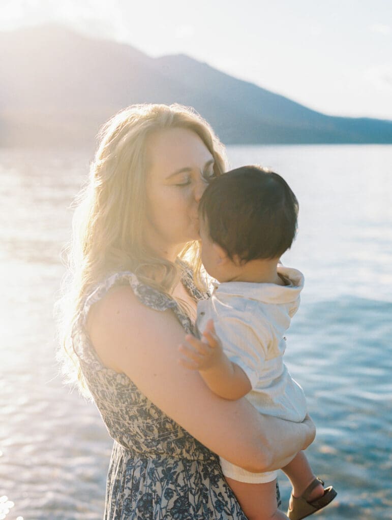 Scenic family photo session at Lake Tahoe, where a photographer captures the essence of mother and child bonds in nature.