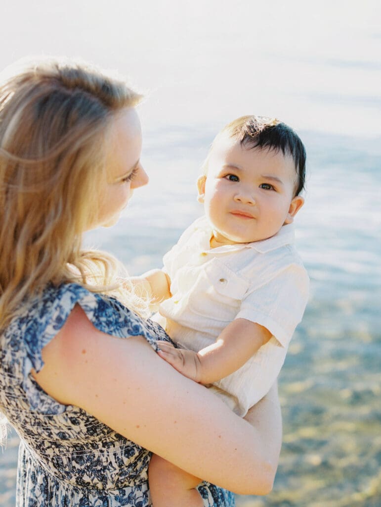 Scenic family photo session at Lake Tahoe, where a photographer captures the essence of mother and child bonds in nature.