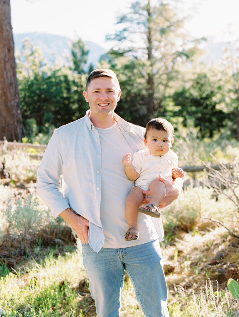 Scenic family photo session at Lake Tahoe, where a photographer captures the essence of dad and a child bonds in nature.