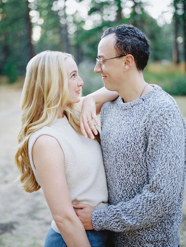 A couple embraces during a family photo session at Lake Tahoe, capturing a moment of love and connection.