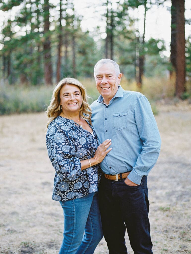 Grandparents embraces during a family photo session at Lake Tahoe, capturing a moment of love and connection.