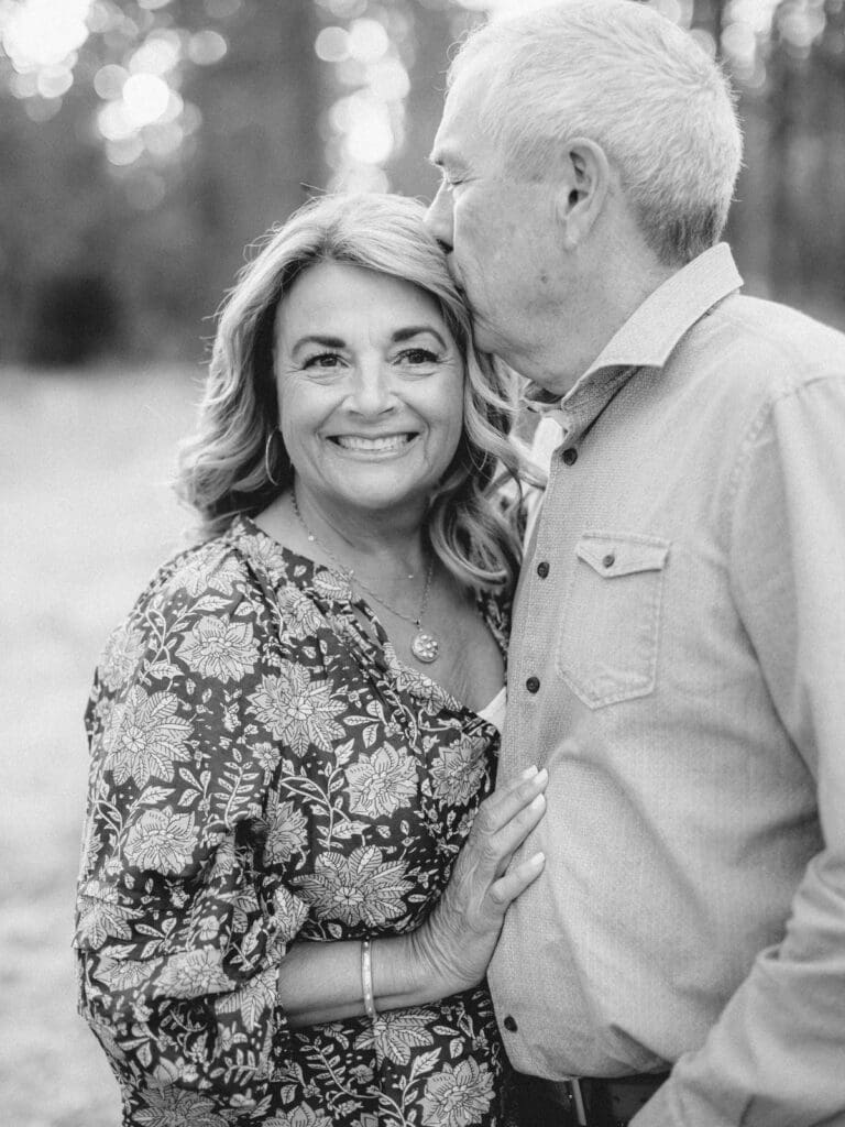 Grandparents embraces during a family photo session at Lake Tahoe, capturing a moment of love and connection.