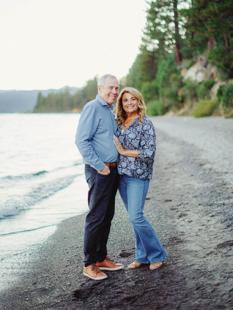 Grandparents standing on the beach during a family photo session at Lake Tahoe, capturing a moment of love and connection.