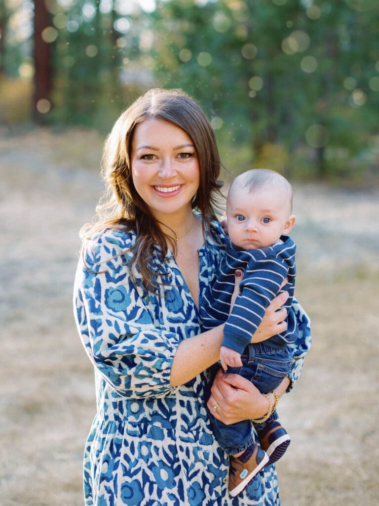 Mother and son poses together in a lush field surrounded by trees during their Lake Tahoe photo session.