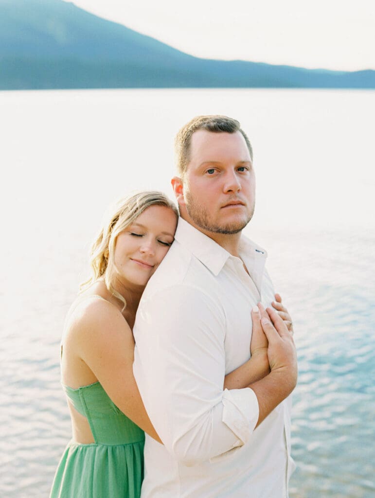 Engagement photos at Lake Tahoe, capturing a dreamy sunset with mountains in the background.