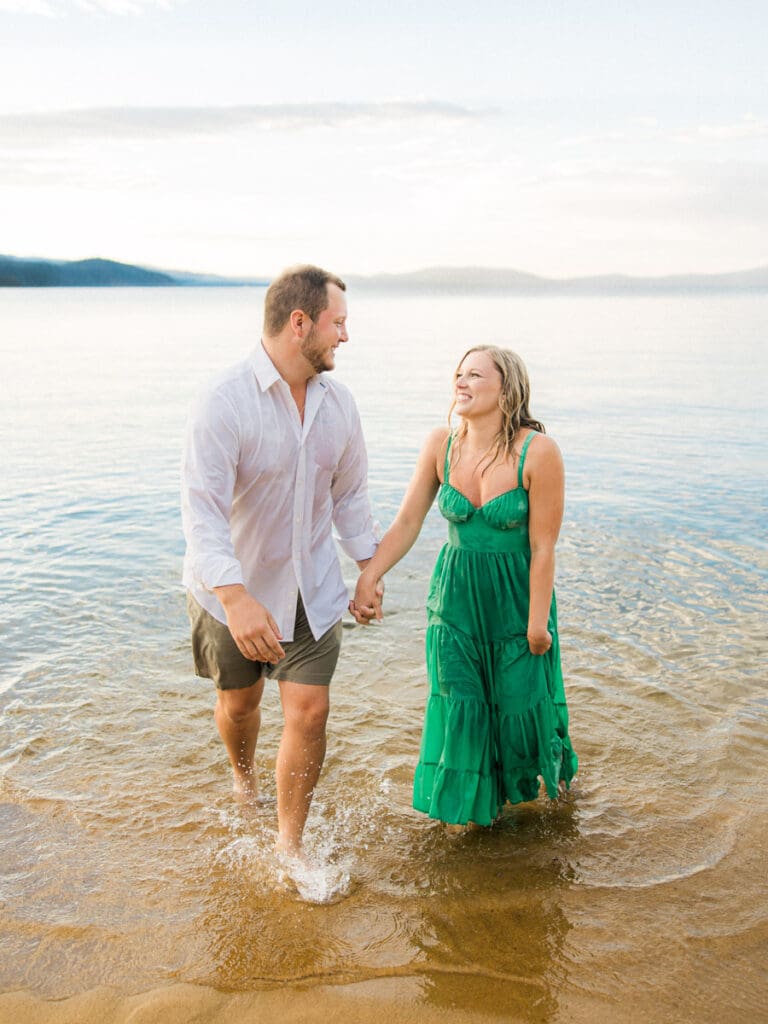 Romantic engagement photos at Lake Tahoe, featuring a stunning sunset and majestic mountains.