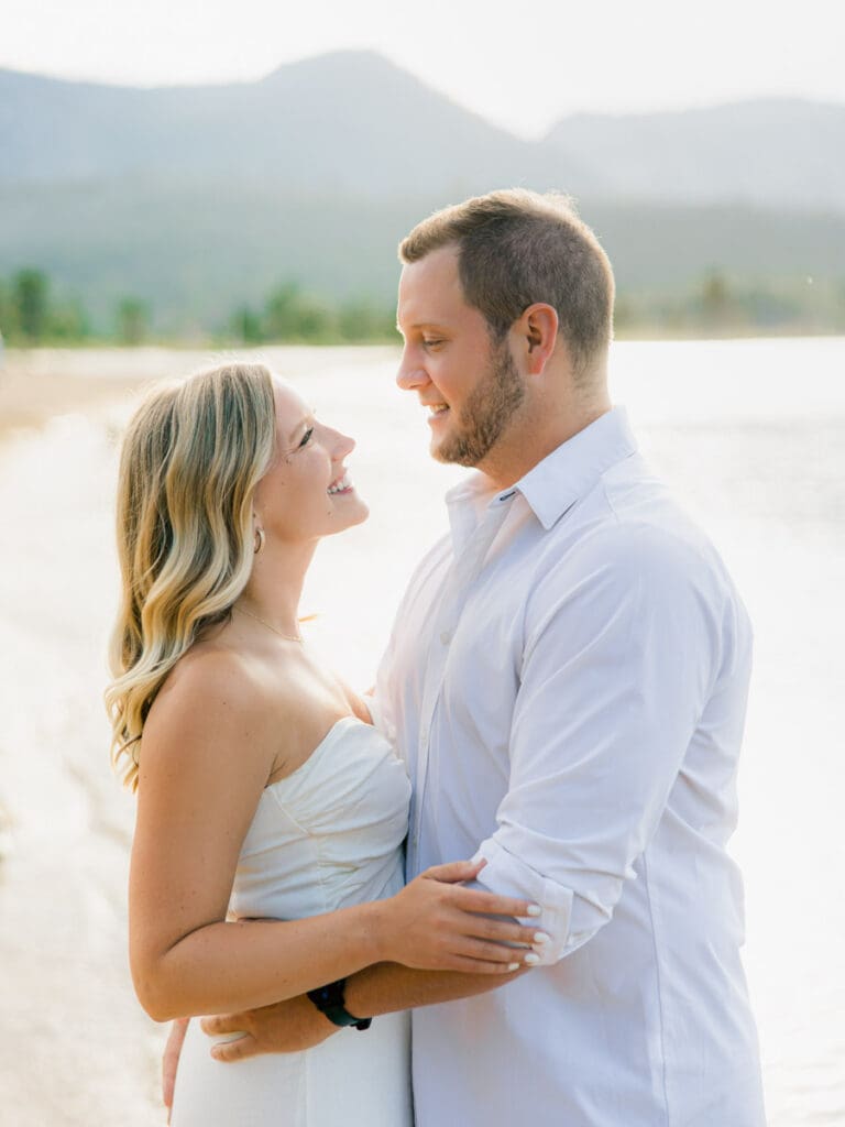 Captivating engagement photos at Lake Tahoe, with a breathtaking sunset and scenic mountain backdrop.