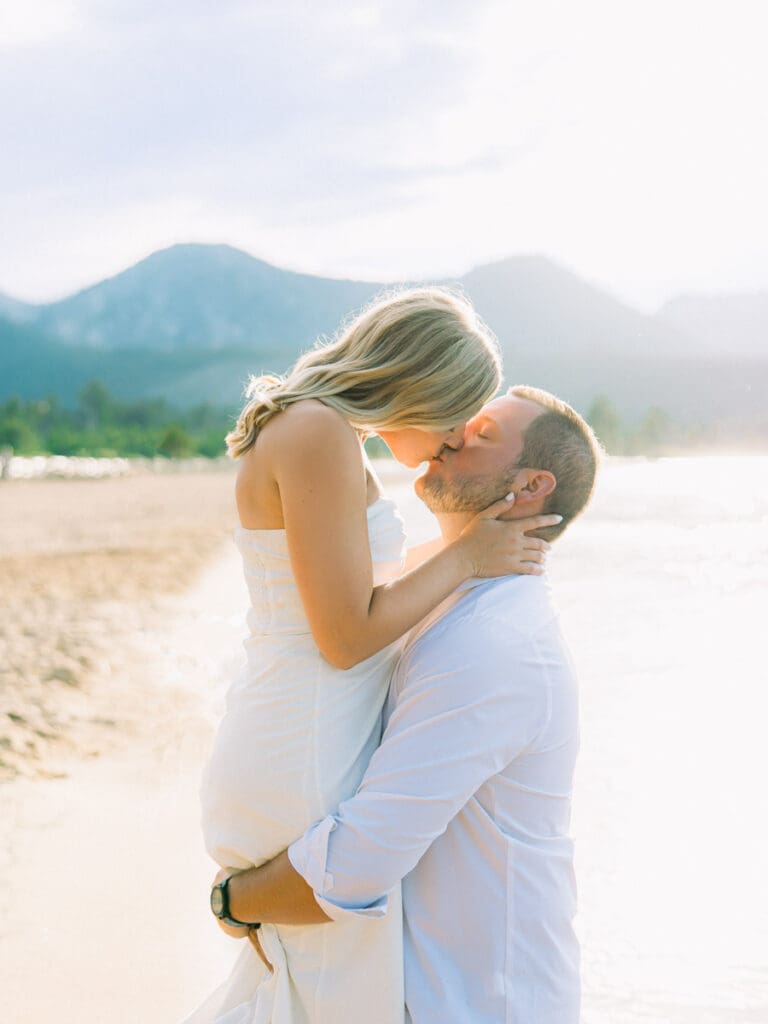 Captivating engagement photos at Lake Tahoe, with a breathtaking sunset and scenic mountain backdrop.