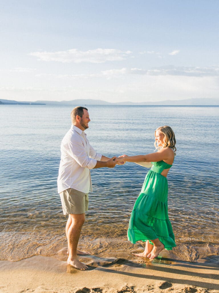 Couple dances during Captivating engagement photos at Lake Tahoe, with a breathtaking sunset and scenic mountain backdrop.