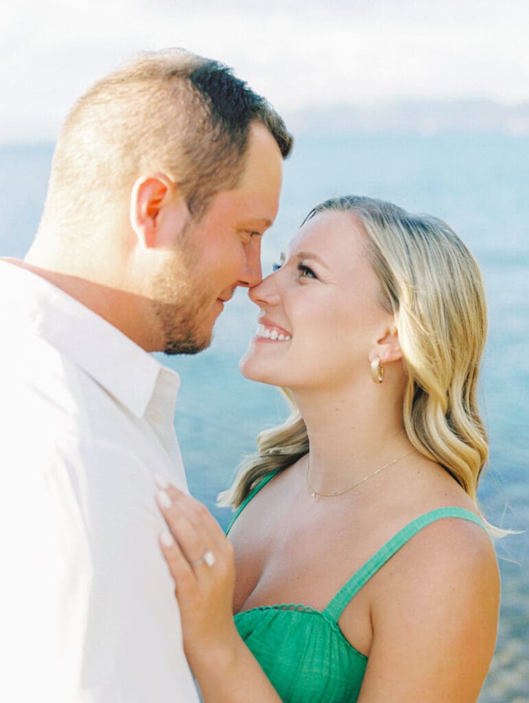 Engagement photos at Lake Tahoe, capturing a dreamy sunset with mountains in the background.