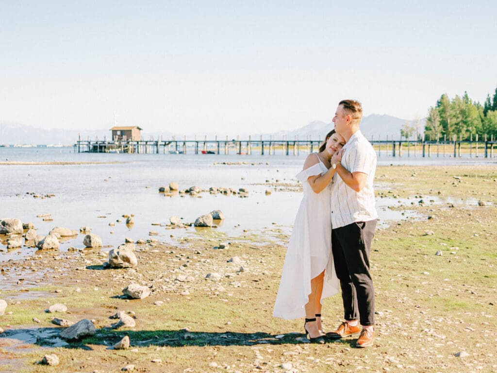 An engaged couple poses together at Lake Tahoe, capturing their love amidst the picturesque Tahoe nature landscape.