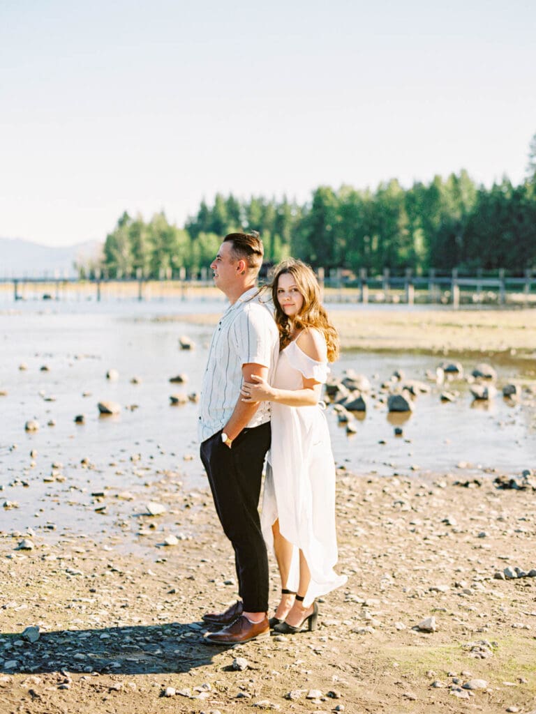 An engaged couple poses together at Lake Tahoe, capturing their love amidst the picturesque Tahoe nature landscape.