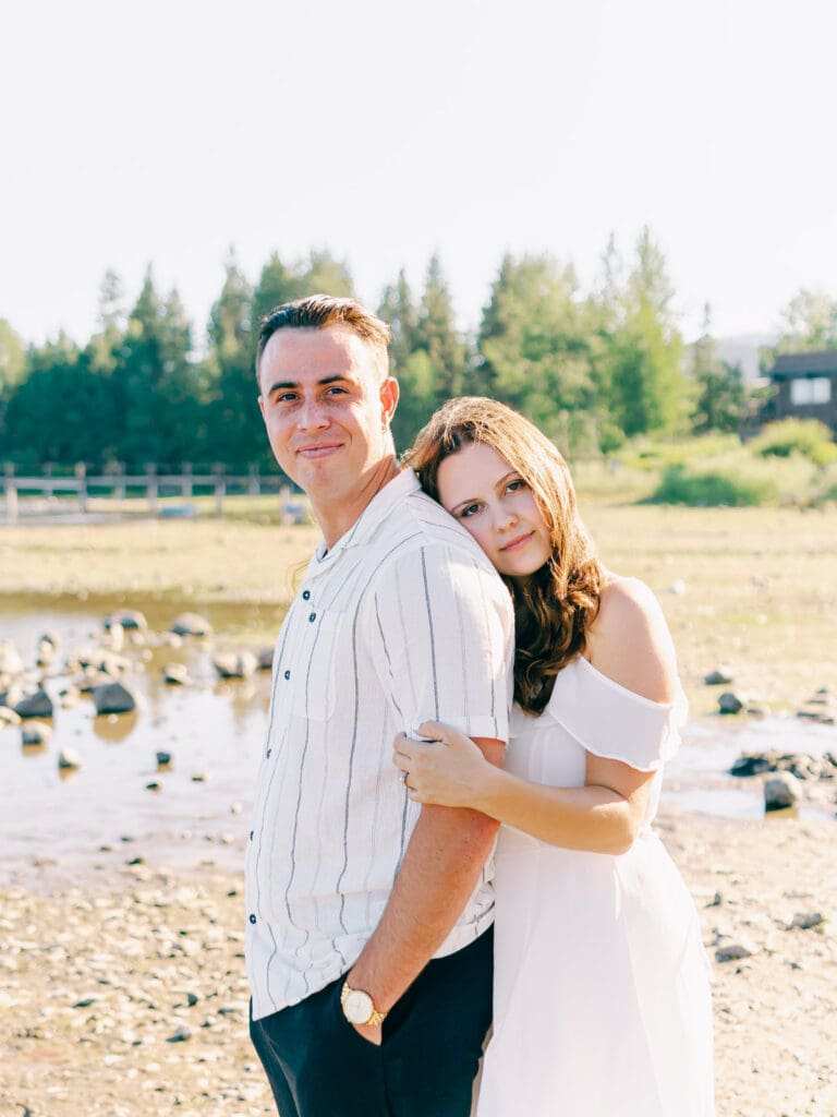 An engaged couple poses together at Lake Tahoe, capturing their love amidst the picturesque Tahoe nature landscape.