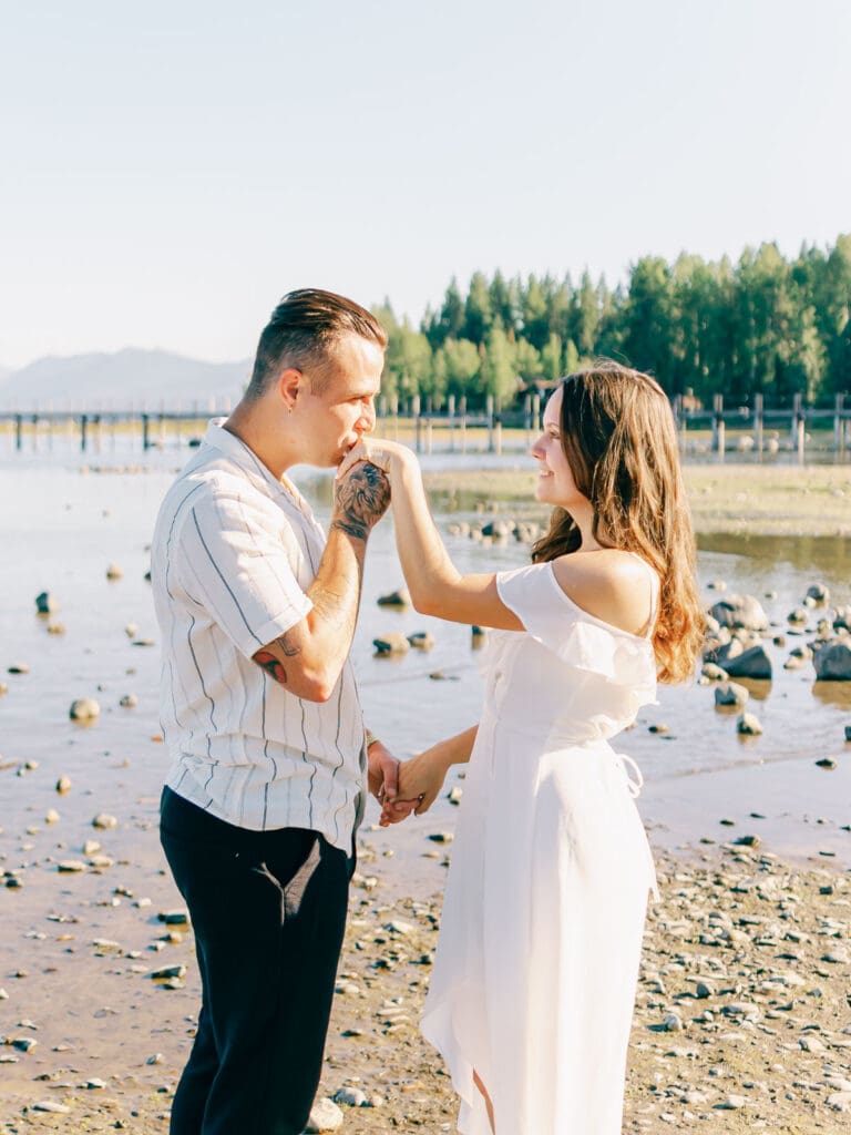 An engaged couple poses together at Lake Tahoe, capturing their love amidst the picturesque Tahoe nature landscape.