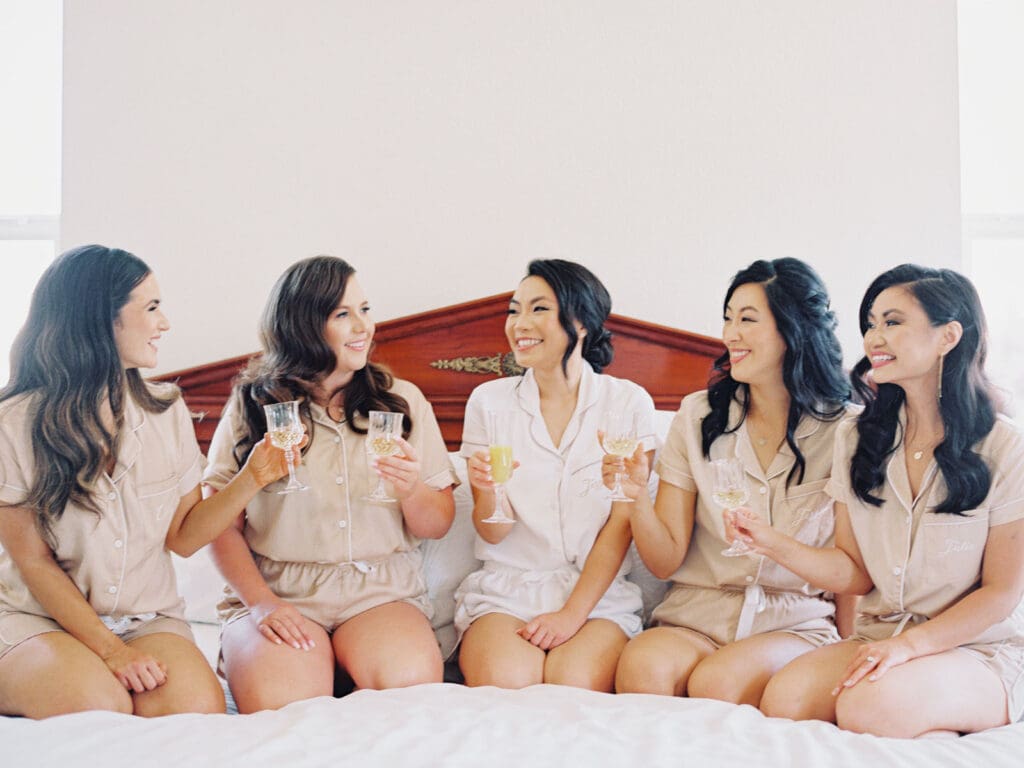 Bridesmaids pose for a wedding photo at Tannenbaum Lake Tahoe, captured by the photographer.