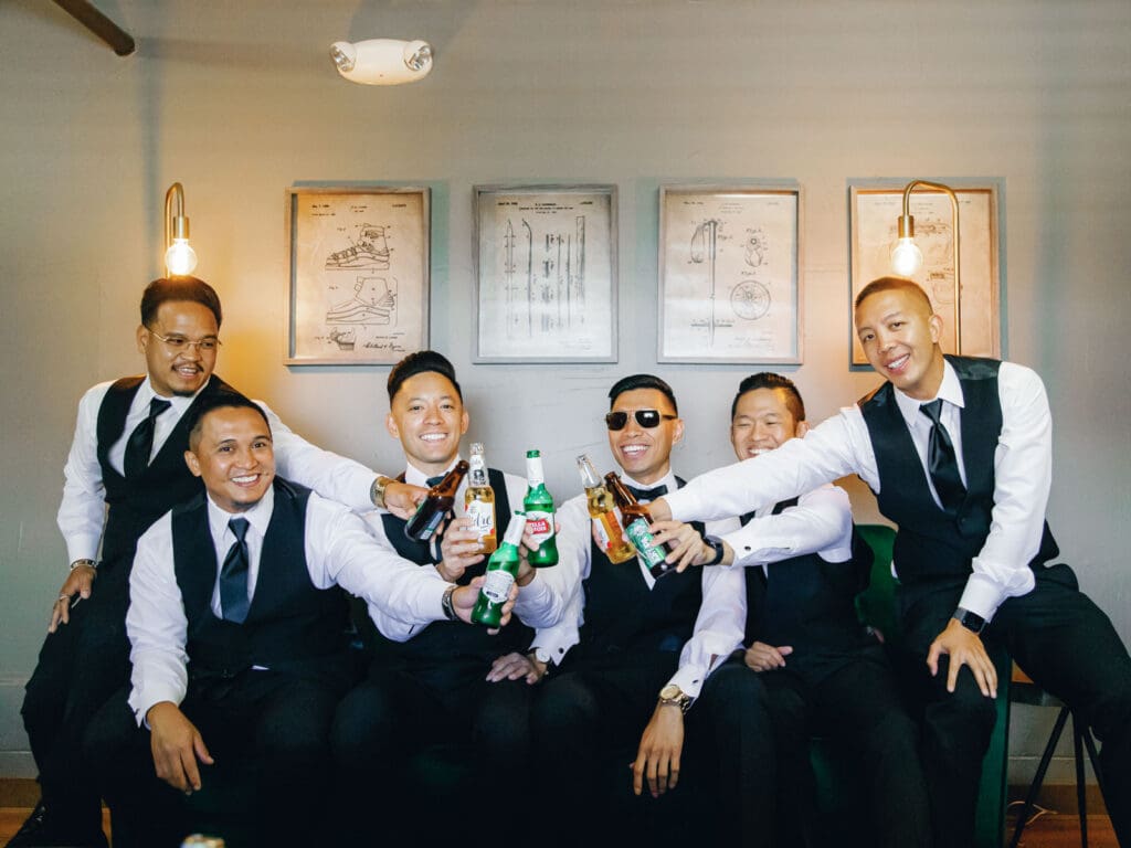 Groom and groomsmen pose for a photo at Tannenbaum, captured by the photographer.