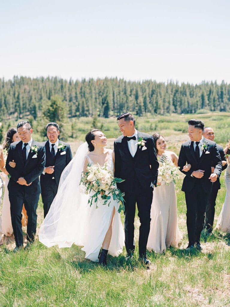 Bridal party smiling at Tannenbaum Lake Tahoe wedding venue, captured by the photographer.