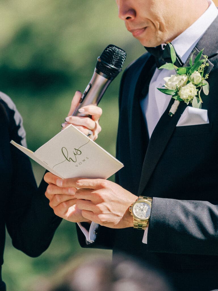 Groom read vows wedding ceremony at Tannenbaum Lodge, set against the breathtaking backdrop of Lake Tahoe's mountains.