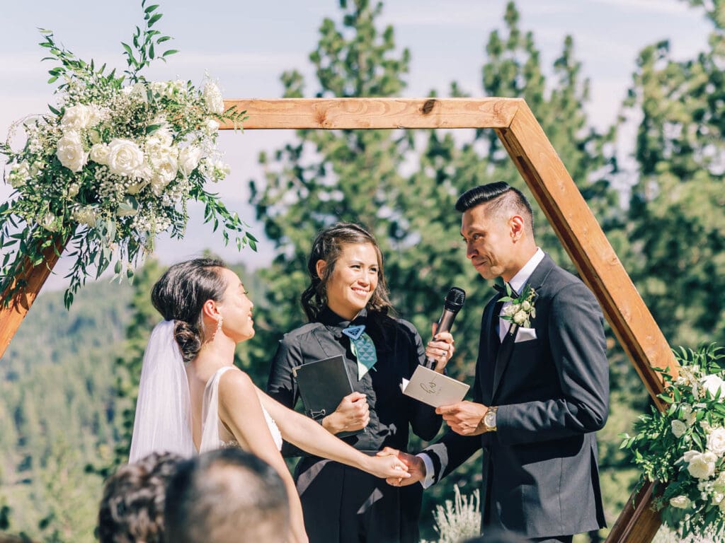 Groom read vows wedding ceremony at Tannenbaum Lodge, set against the breathtaking backdrop of Lake Tahoe's mountains.