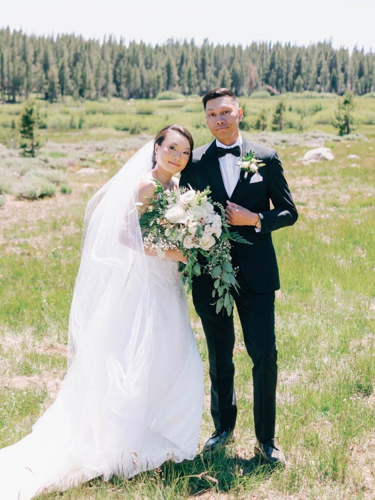 Bride and Groom smiling at Tannenbaum Lake Tahoe wedding venue, captured by the photographer.