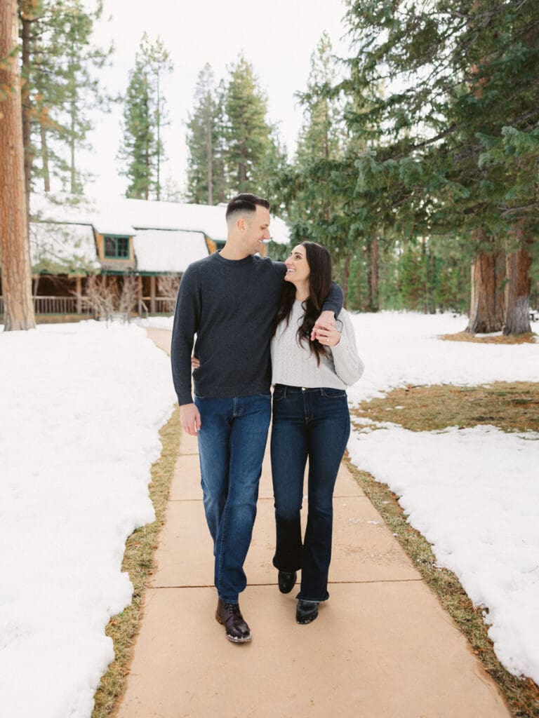 A snowy engagement session in Lake Tahoe, showcasing a couple joyfully celebrating their love in a winter wonderland.