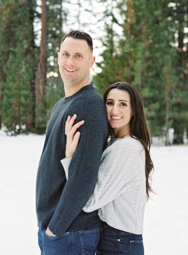 A romantic engagement session in Tahoe, featuring a couple amidst a picturesque snowy backdrop, capturing their love.